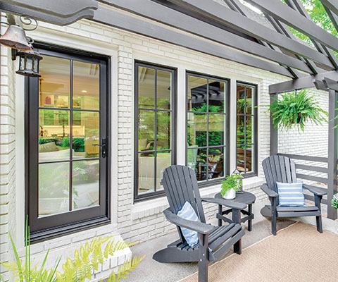 Exterior imagae of an Infinity in-swing French door, casement windows and picture window overlooking a patio